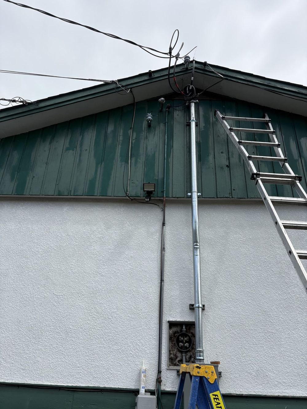 Electrical service mast and conduit riser installed by Tim Braun Electrical on a Chilliwack home